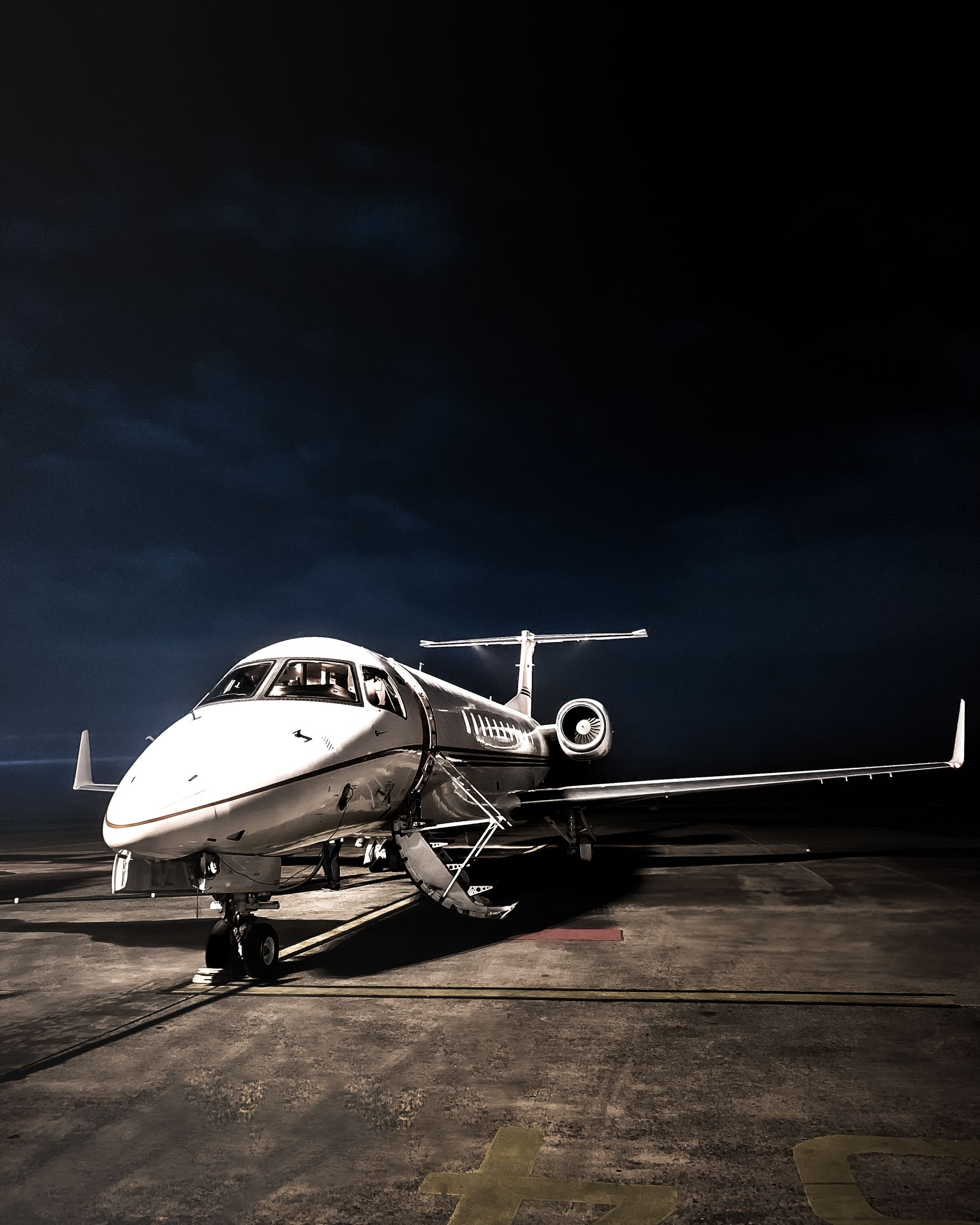 Private jet on the tarmac at night