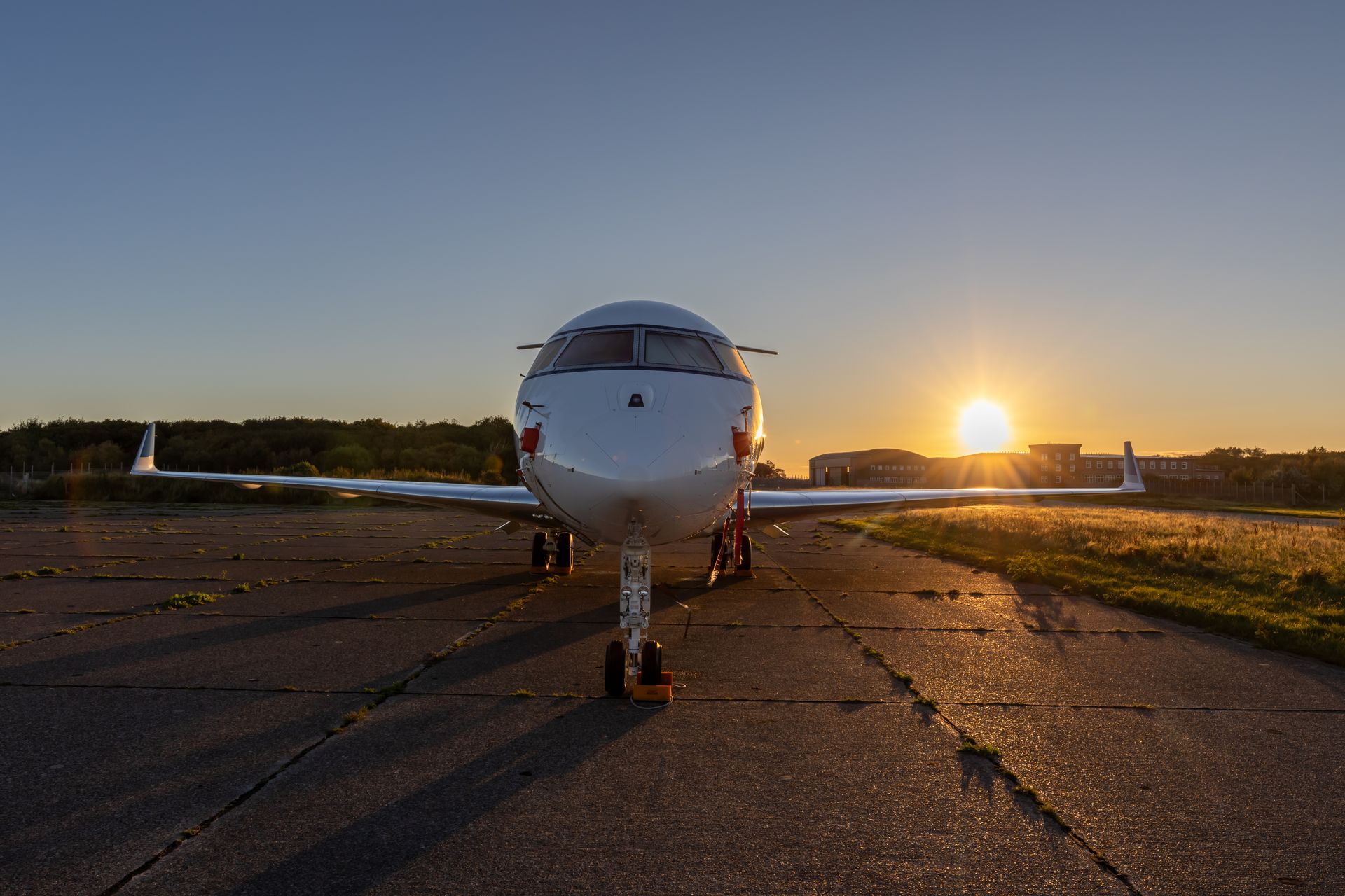 Private jet on the runway at sunset